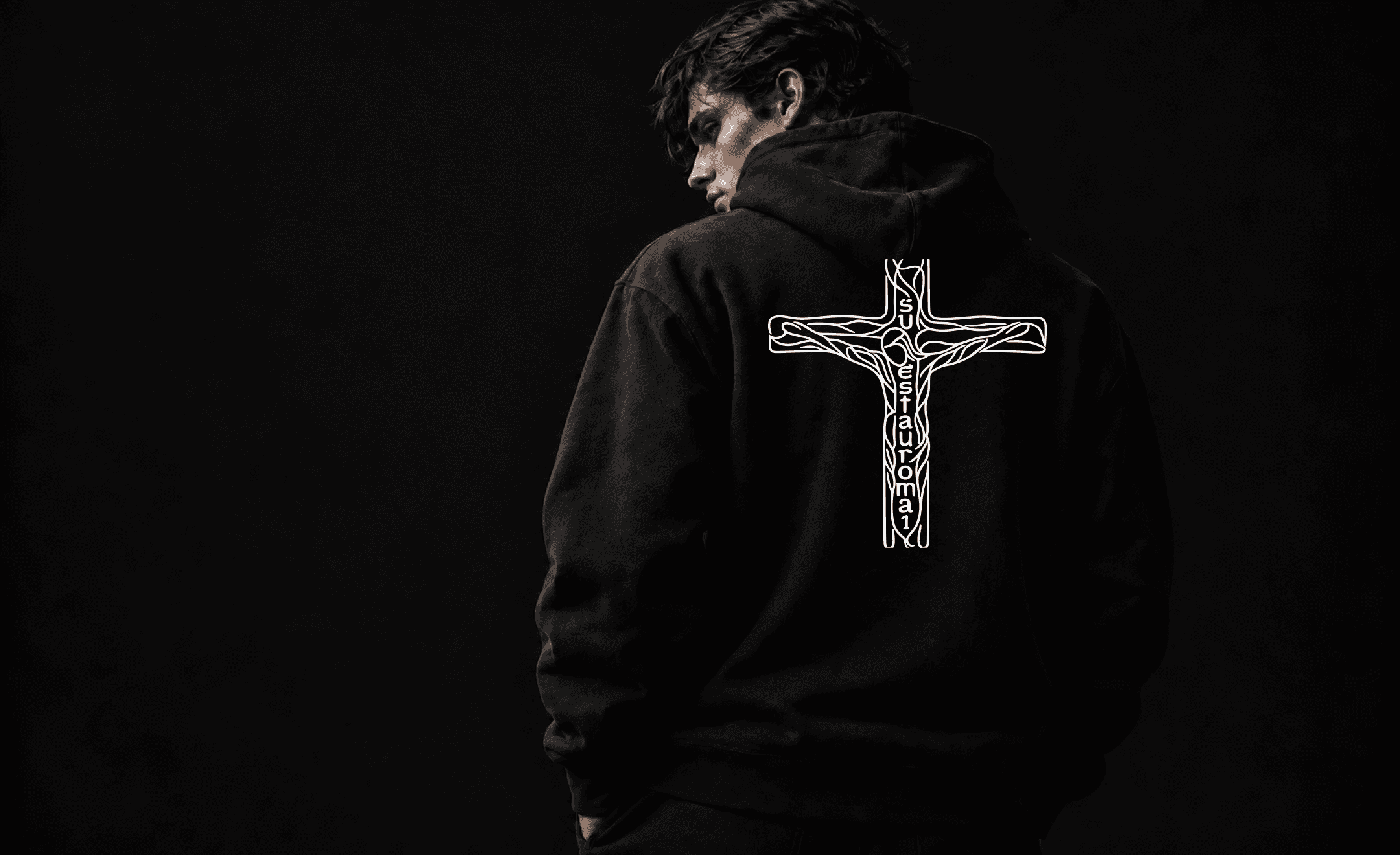 Model wearing the black SUESTAUROMAI hoodie from behind, showing the complete cruciform artwork.
